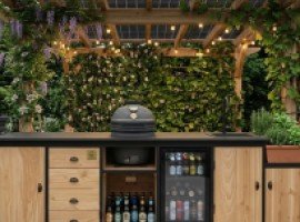 Outdoor kitchen set within a planted garden