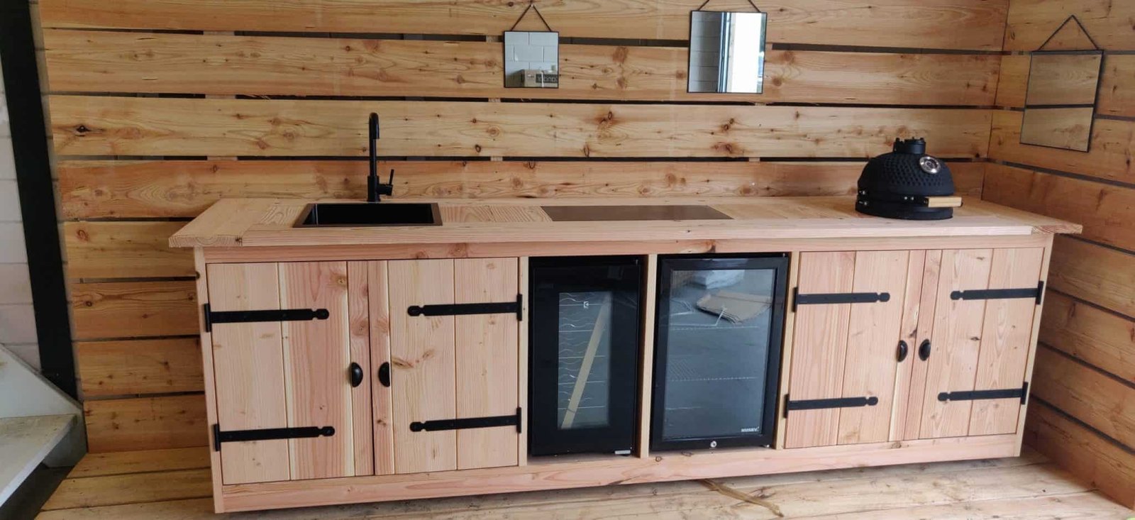 Outdoor kitchens lit at dusk in the showroom